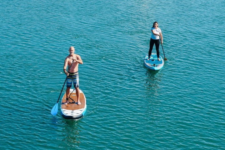 a person standing next to a body of water